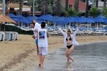 Turistler Muğla'da yağışlı havaya rağmen denize girdiler