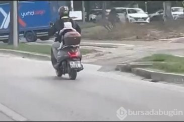 Bursa'da motosiklet sürücüsü baba bebeğini arkasına bağladı