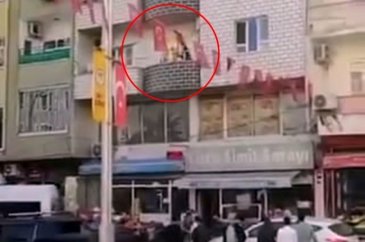 Alev alan tüpü balkondan kalabalığın arasına attı
