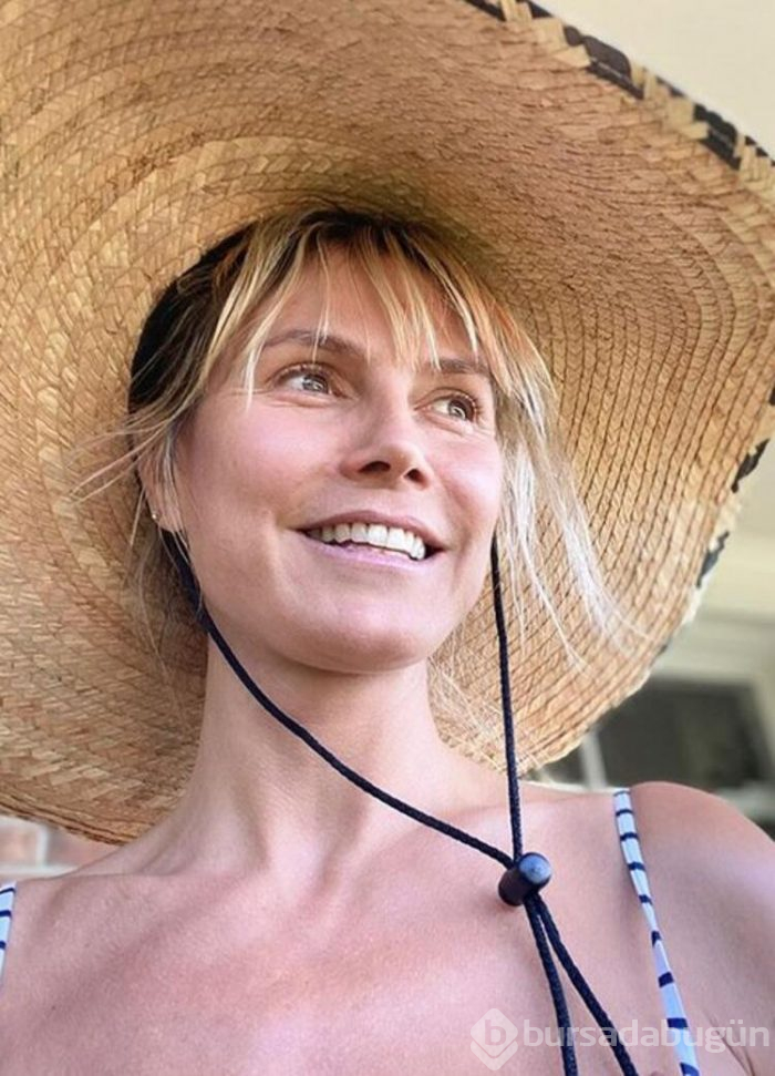 Heidi Klum, havuz başında üstsüz güneşlendi