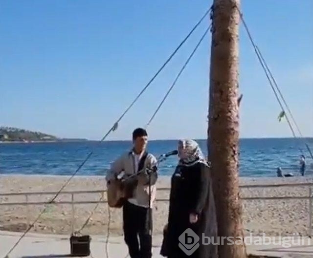 Sokak müzisyeni şarkı söylerken yanına geldi mikrofonu kendisine çekti! Performansı kendine hayran bıraktı