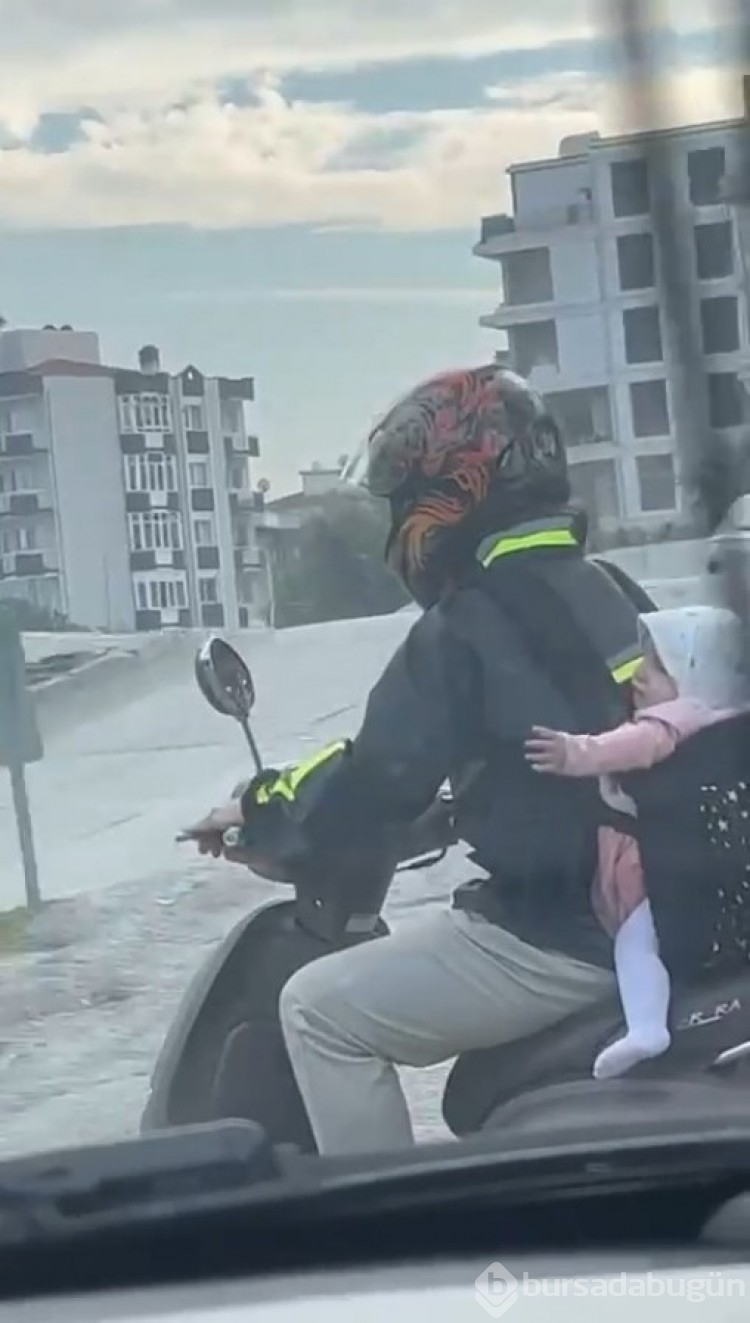 Bursa'da motosiklet sürücüsü baba bebeğini arkasına bağladı