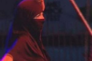 Rock konserinde kara &ccedil;arşaflı dans&ouml;z