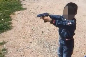 Oğluna tabancayla ateş ettirdiği g&ouml;r&uuml;nt&uuml;lere tepki yağdı