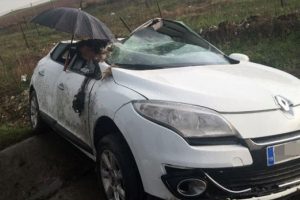 Ara&ccedil;ta sıkışan kadına şemsiyeli koruma