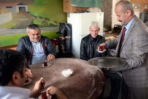 Takım elbiseyle &ccedil;ay servisi yapıyor
