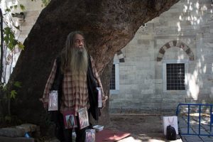 Sahaflar &Ccedil;arşısı'nın sembol ismi kitaplarını &uuml;st&uuml;ne asarak satıyor