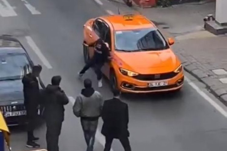 İstanbul'da bir kişi taksinin kaputunun &uuml;zerine yattı
