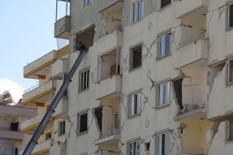 Canlarını hi&ccedil;e sayıp ağır hasarlı binalardan eşya taşıyorlar