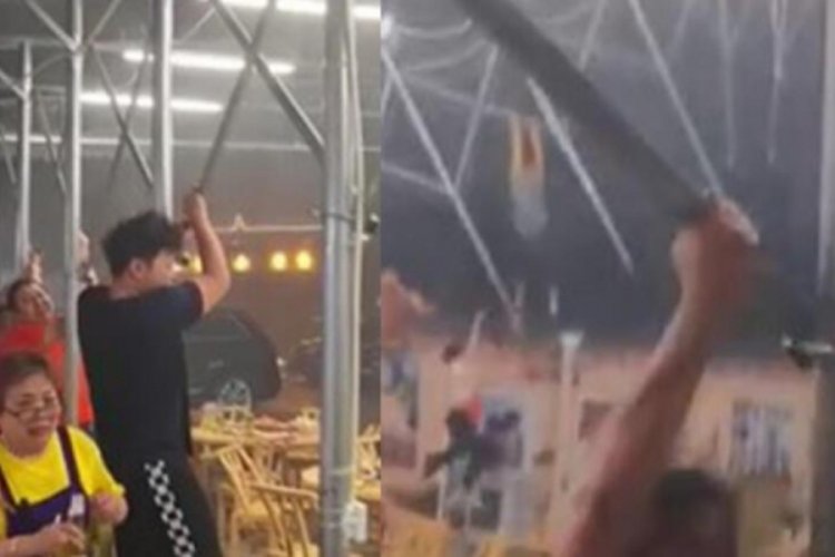 &Ccedil;in'de şiddetli r&uuml;zgar sebebiyle tenteye tutunan insanlar u&ccedil;tu!
