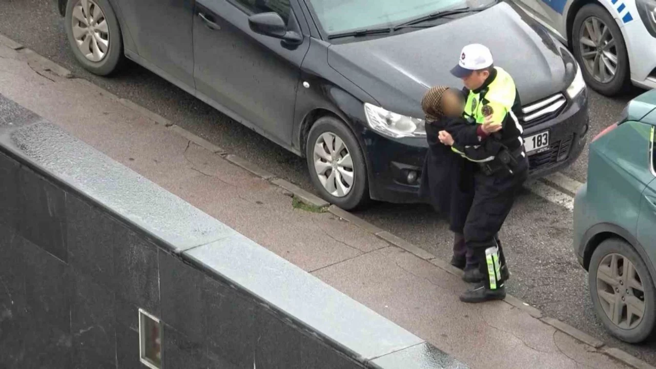 Trafik polisi, kazada yaralanan kadını yeleğiyle yağmurdan korudu! 
