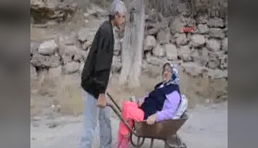 Kanser hastası adam felçli eşini el arabasında hastaneye götürüyor